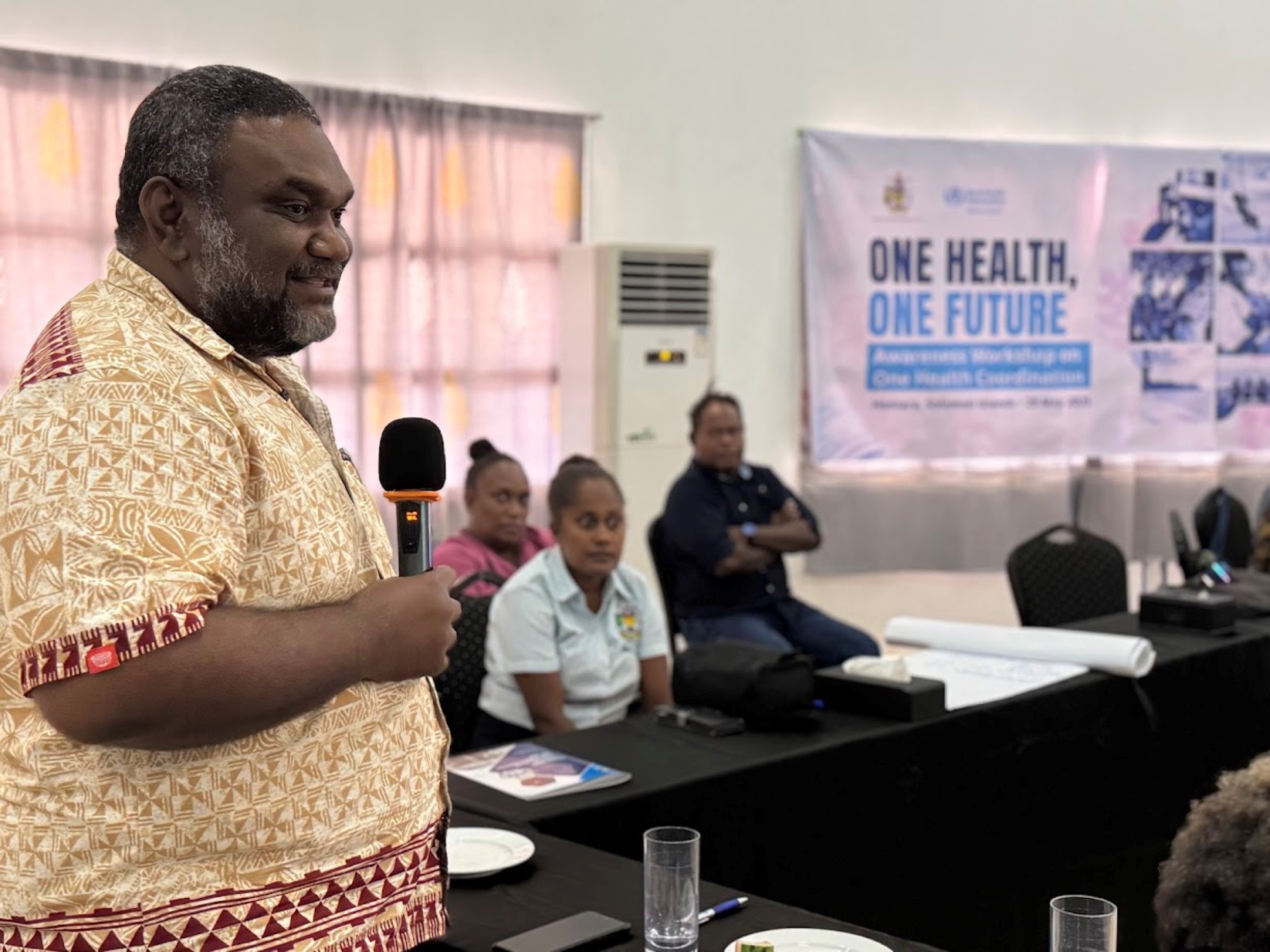 A senior health official addressing the audience.