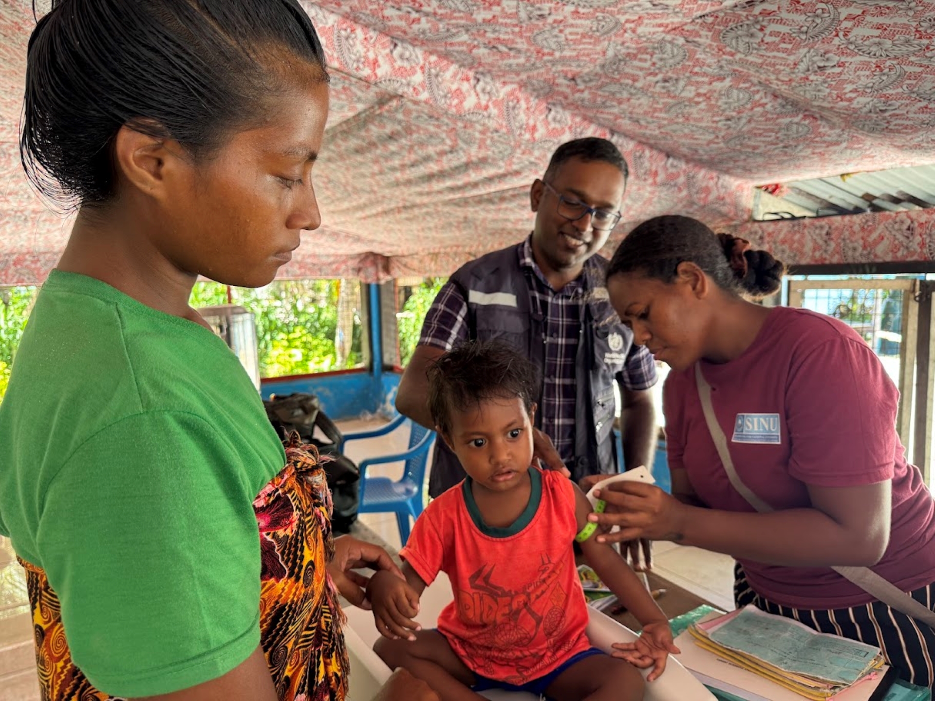 Health workers attending to a child