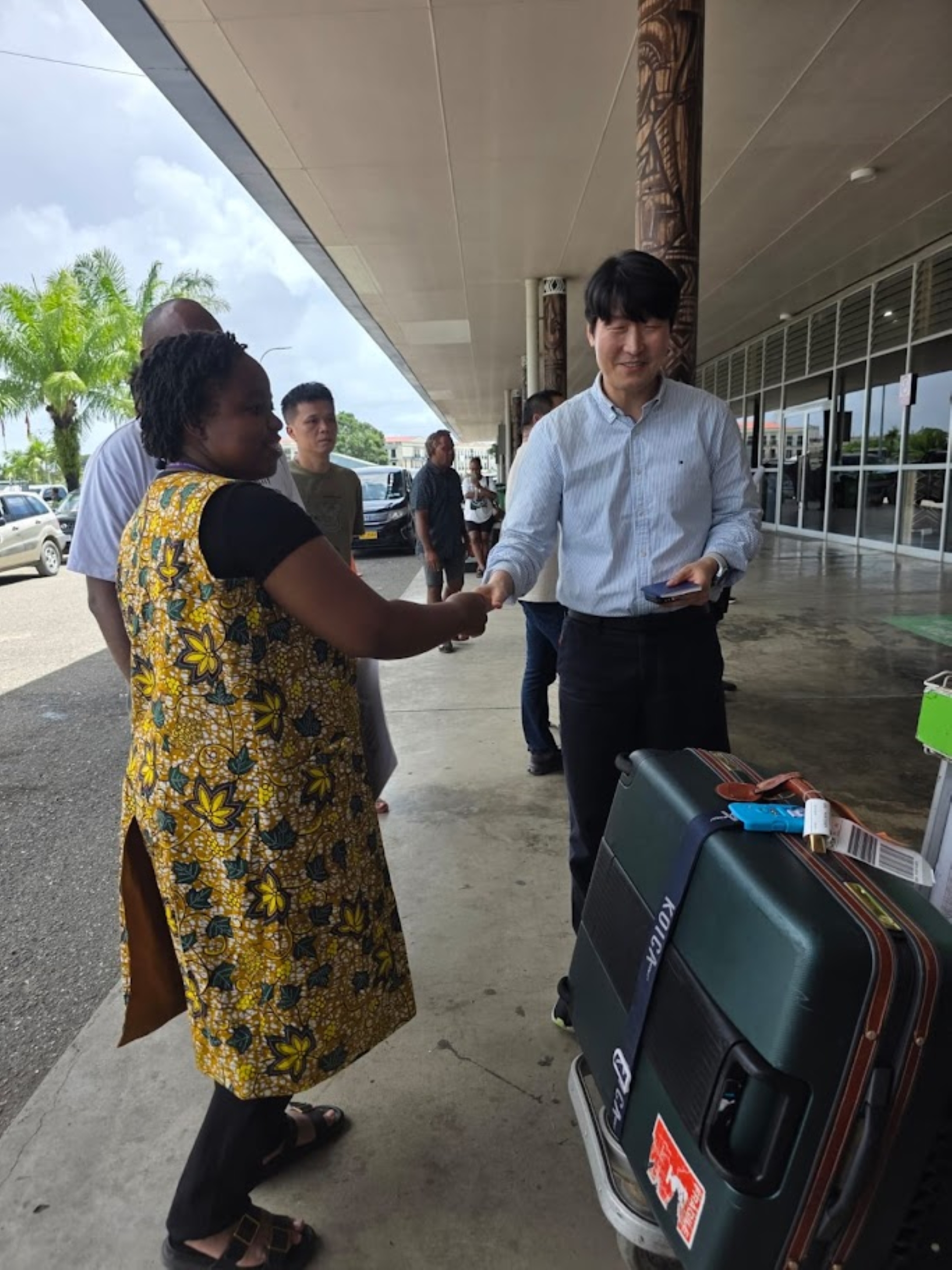 A woman welcoming a visitor.