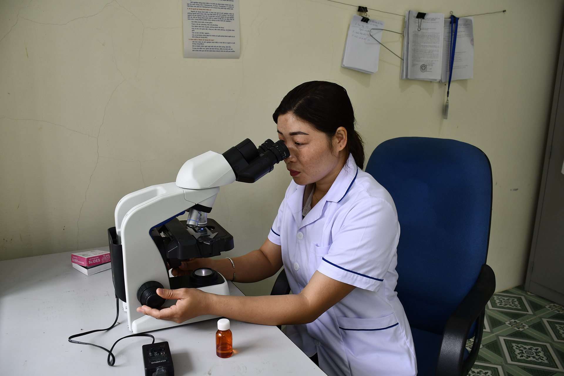 Vang Thi Hac conducts malaria microscopy
