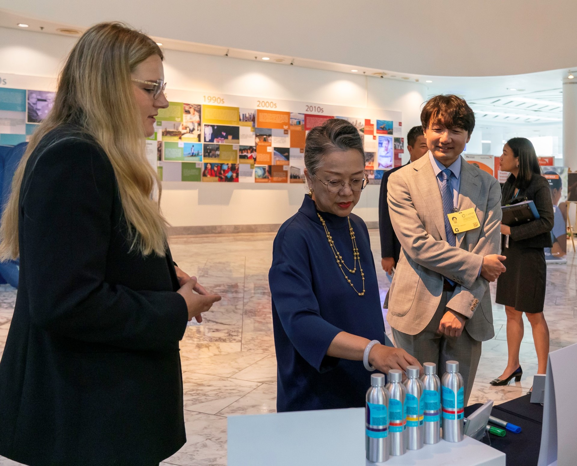 Three people at the Museum of Health Futures exhibit in Thailand