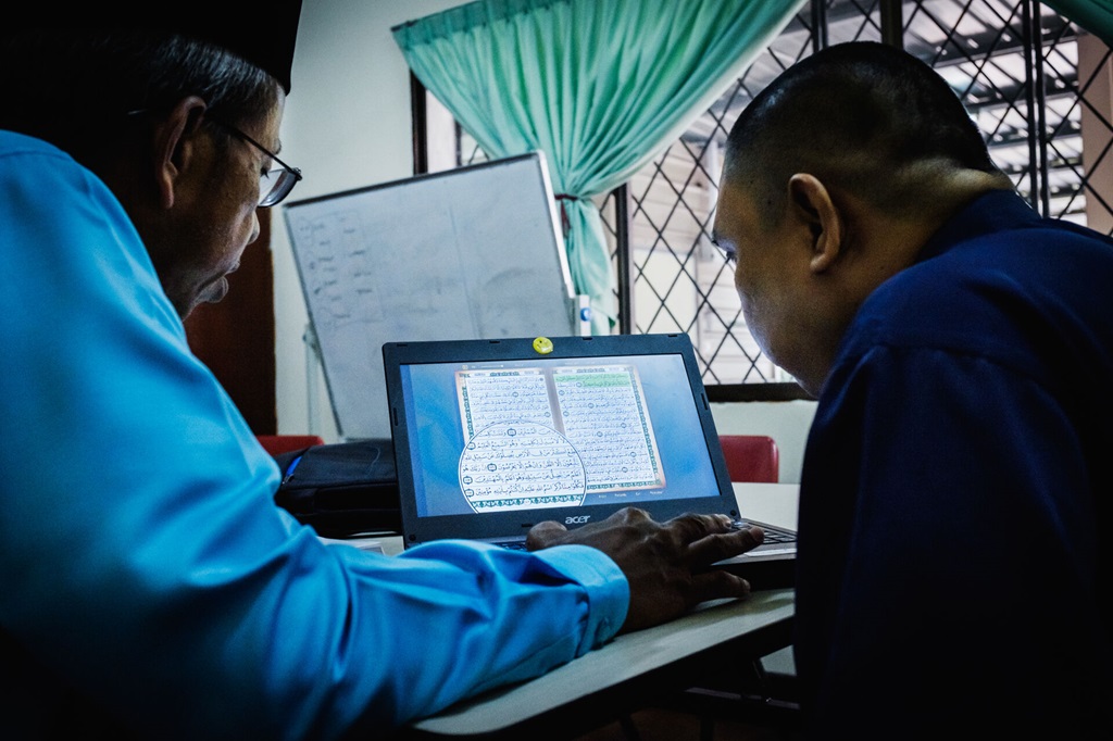 Healthcare staff reviewing patient notes in the Mental Health Unit at Berakas Health Center.
