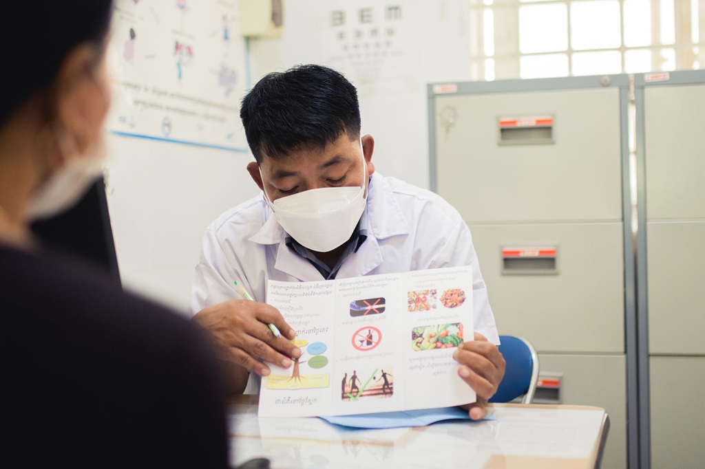 Mr Prak Puth Rotha gives consultation to a patient
