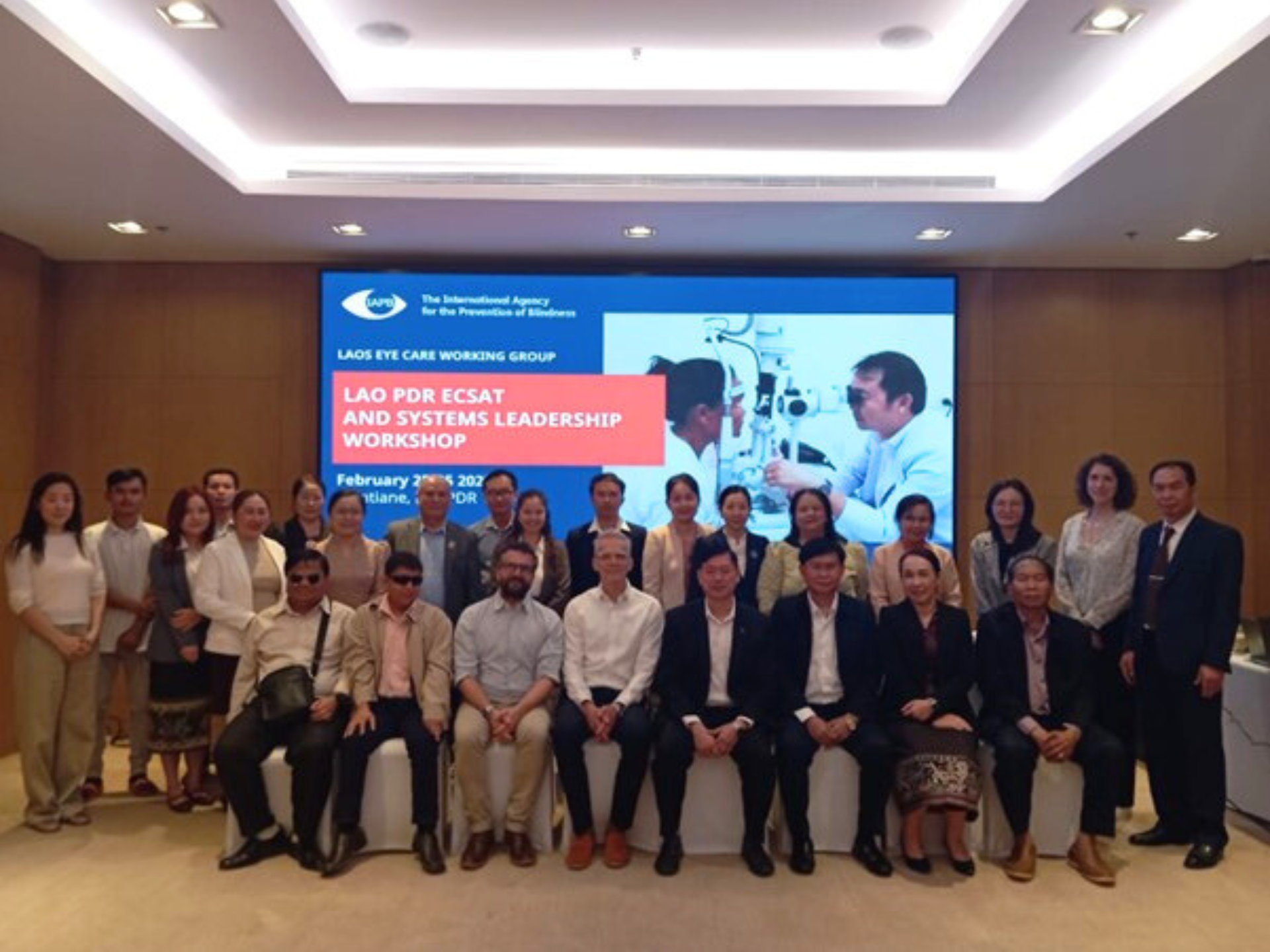 People in a workshop group photo in the Lao People's Democratic Republic