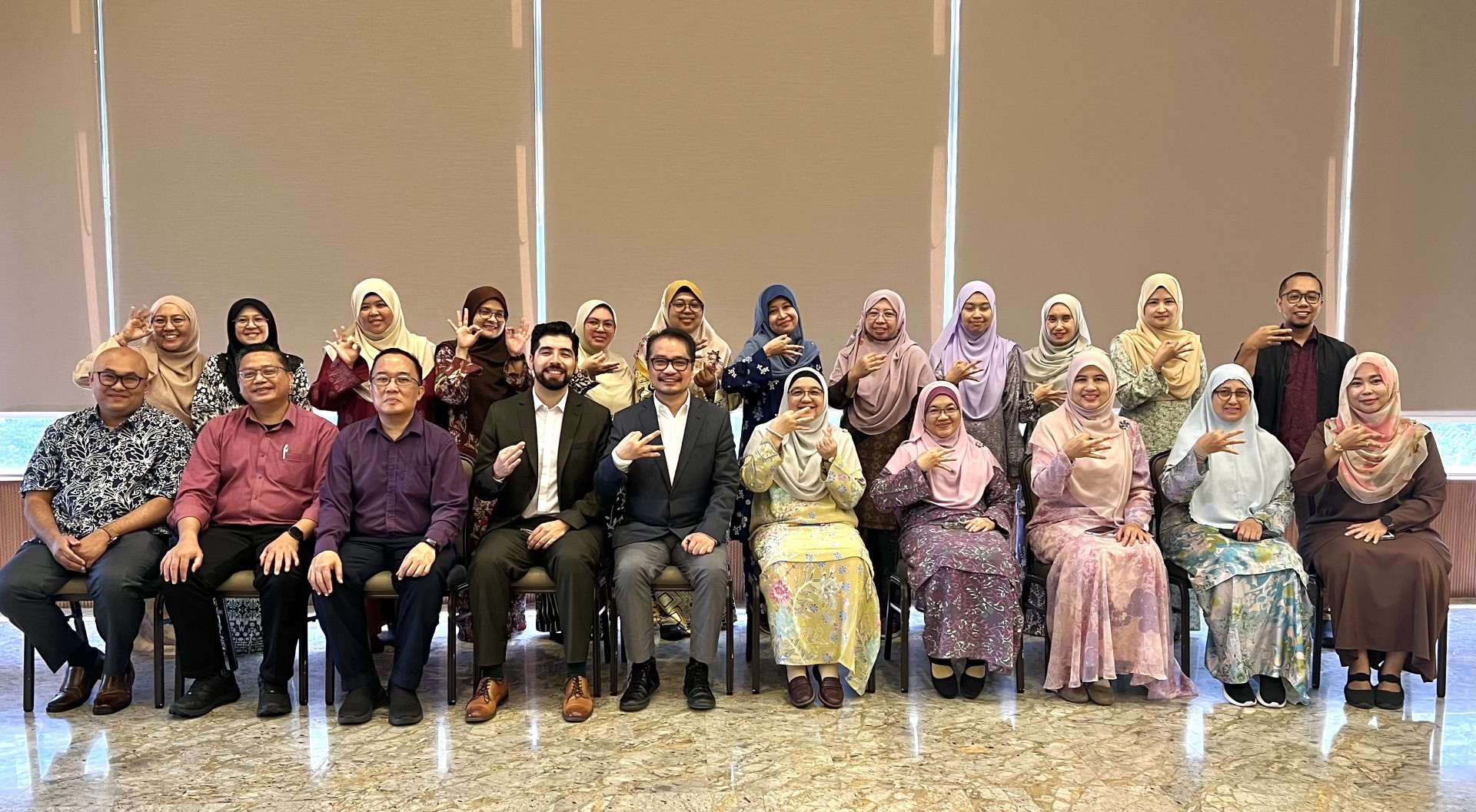 A group of people in Malaysia inside a conference hall
