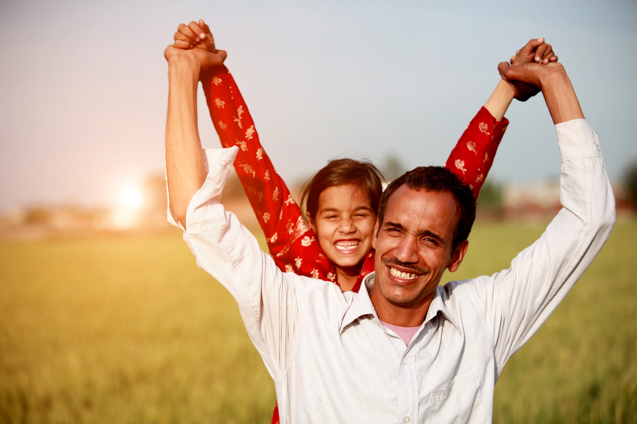 Little girl playing with his father outdoor in the nature image