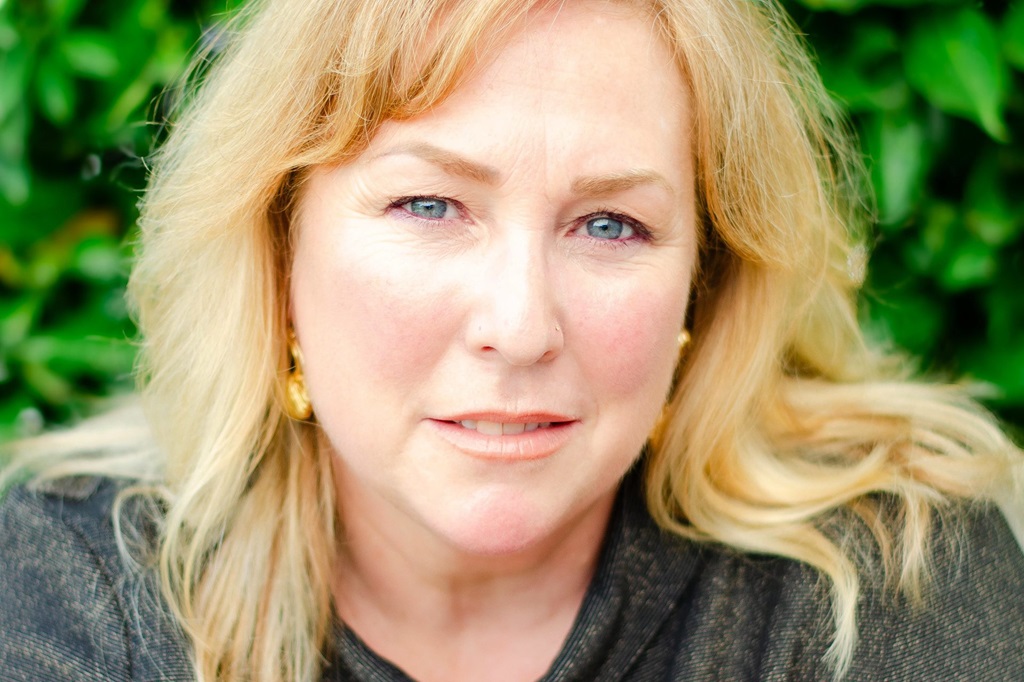 Close headshot of a woman looking into the camera.