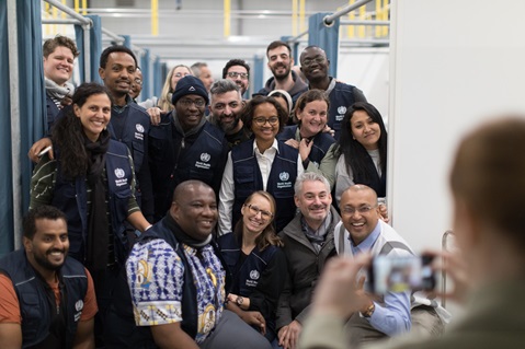 Group photo of WHO staff, smiling and laughing as they pose for a photo.
