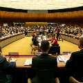 A meeting room with people and cameraman