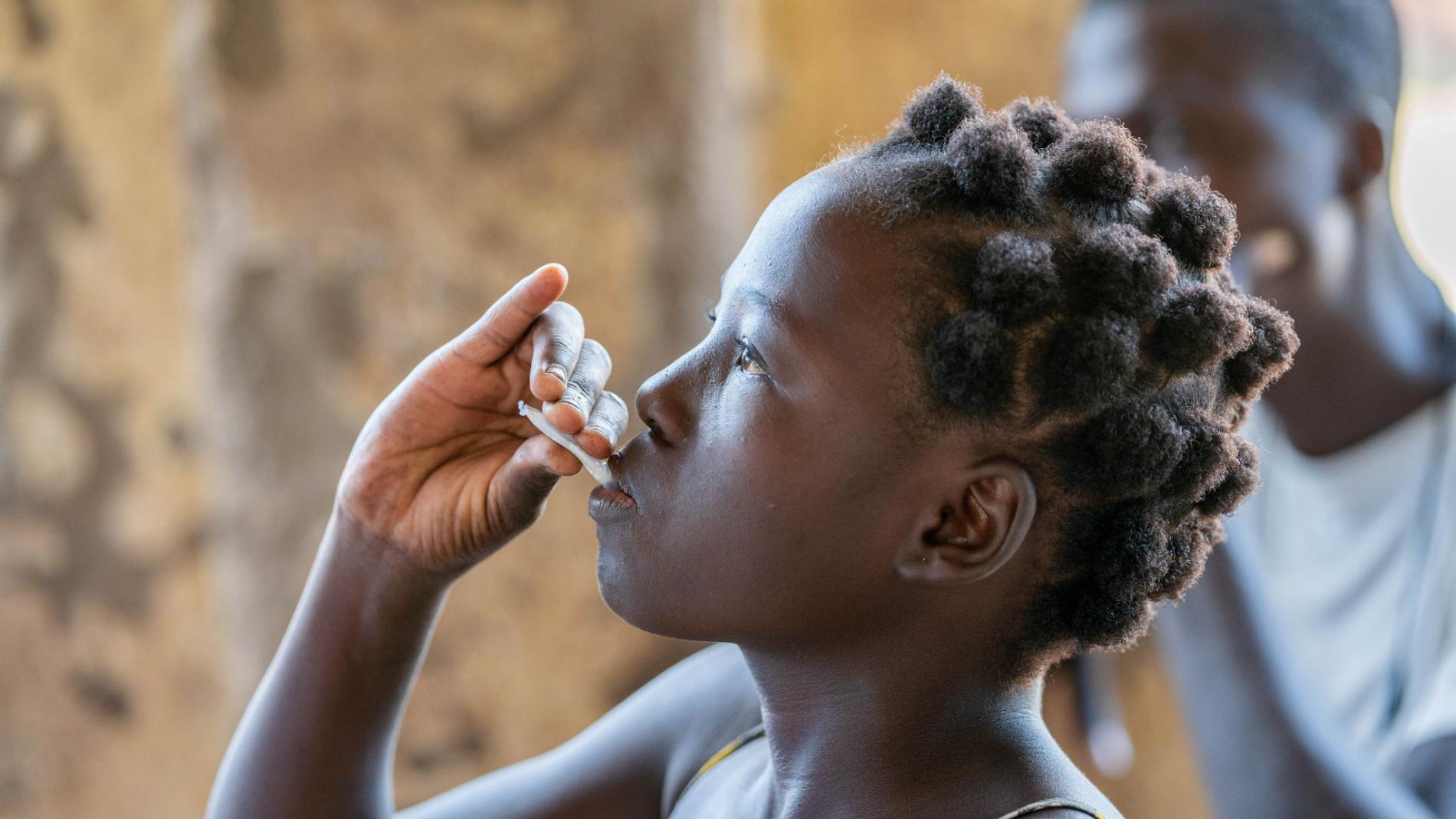 Girl taking cholera vaccine