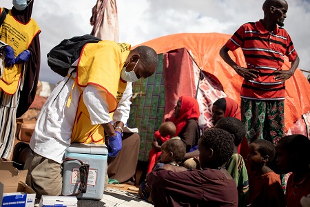 Health workers use vaccine carriers to store vaccines