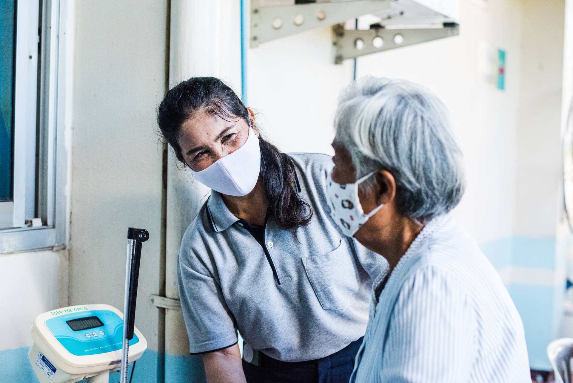 A village health volunteer gives advice to a patient