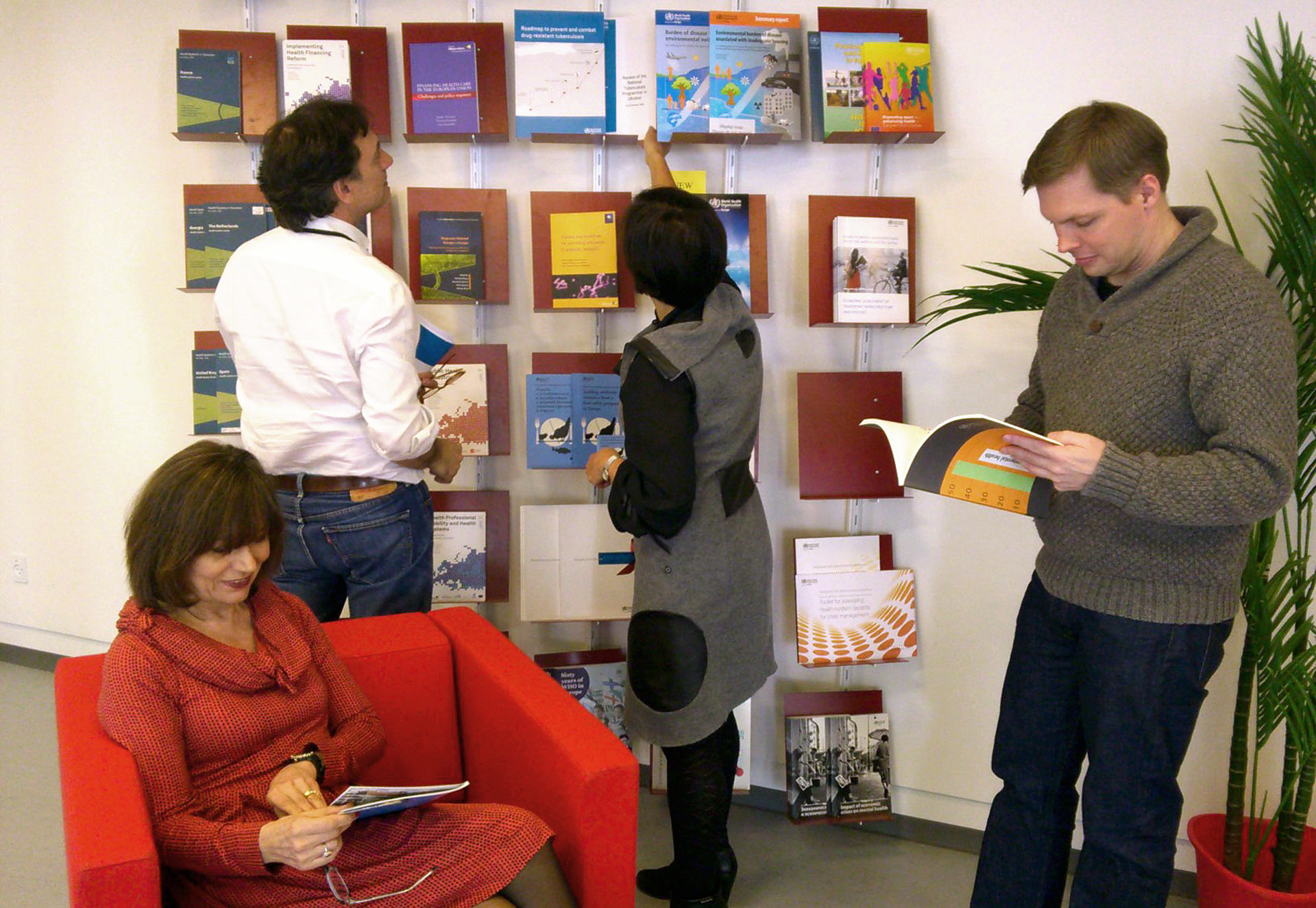 People browsing books in the WHO Europe library.