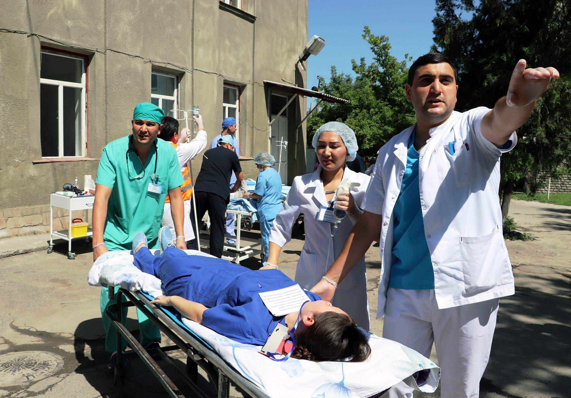 Medical workers carrying patients on stretchers