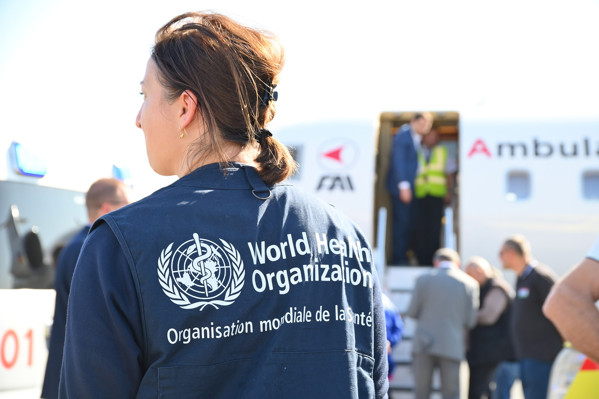 WHO worker on the runway, in front of a medical evacuation aircraft - part of a medical evacuation of burns survivors in Yerevan, Armenia.