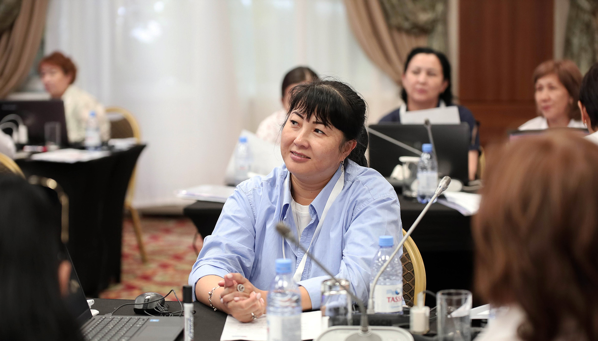 Person at a meeting, promoting the 'Immune Patrol' educational computer game