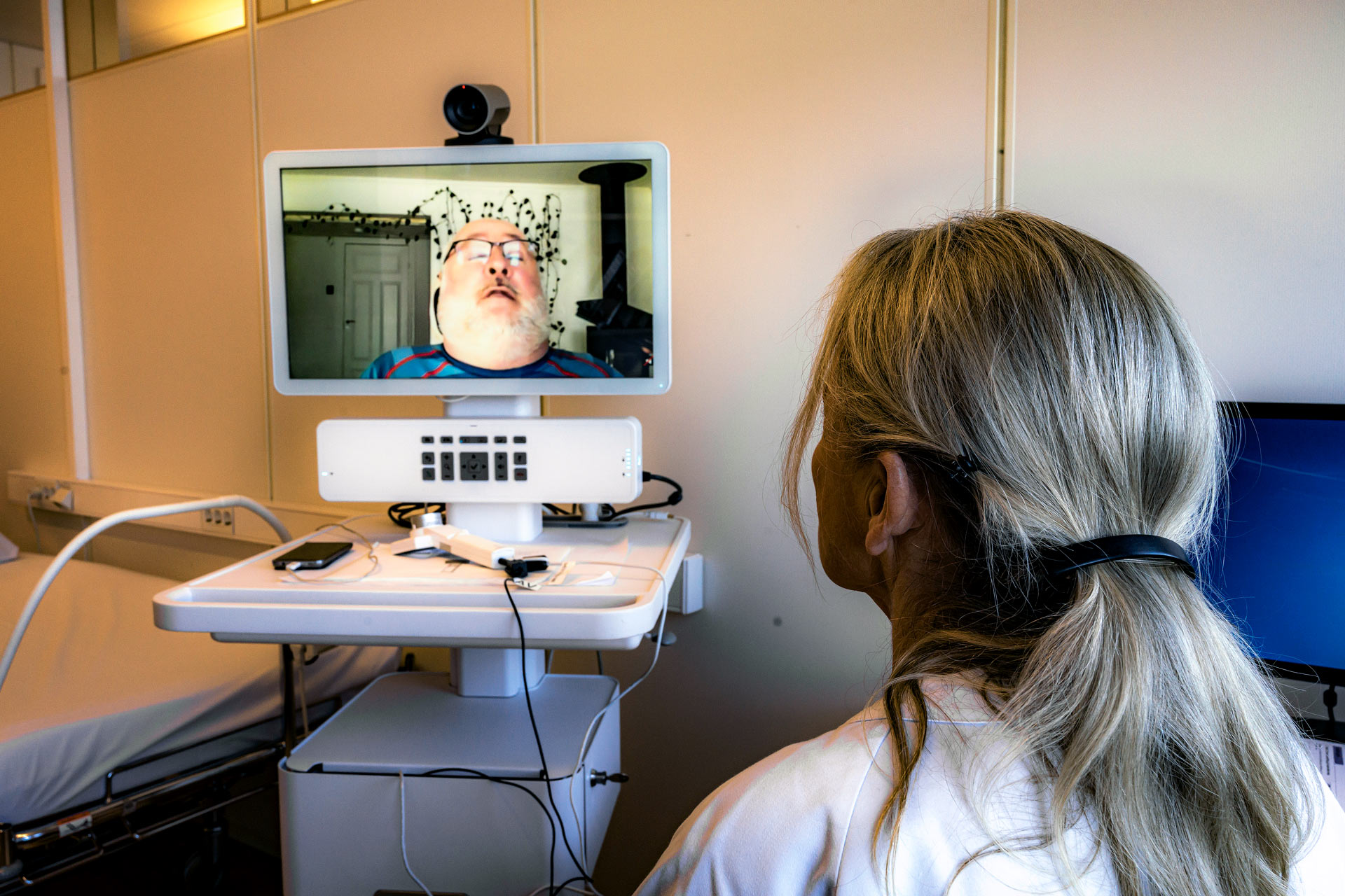 Nurse during a Videoconference appointment from home with patient.