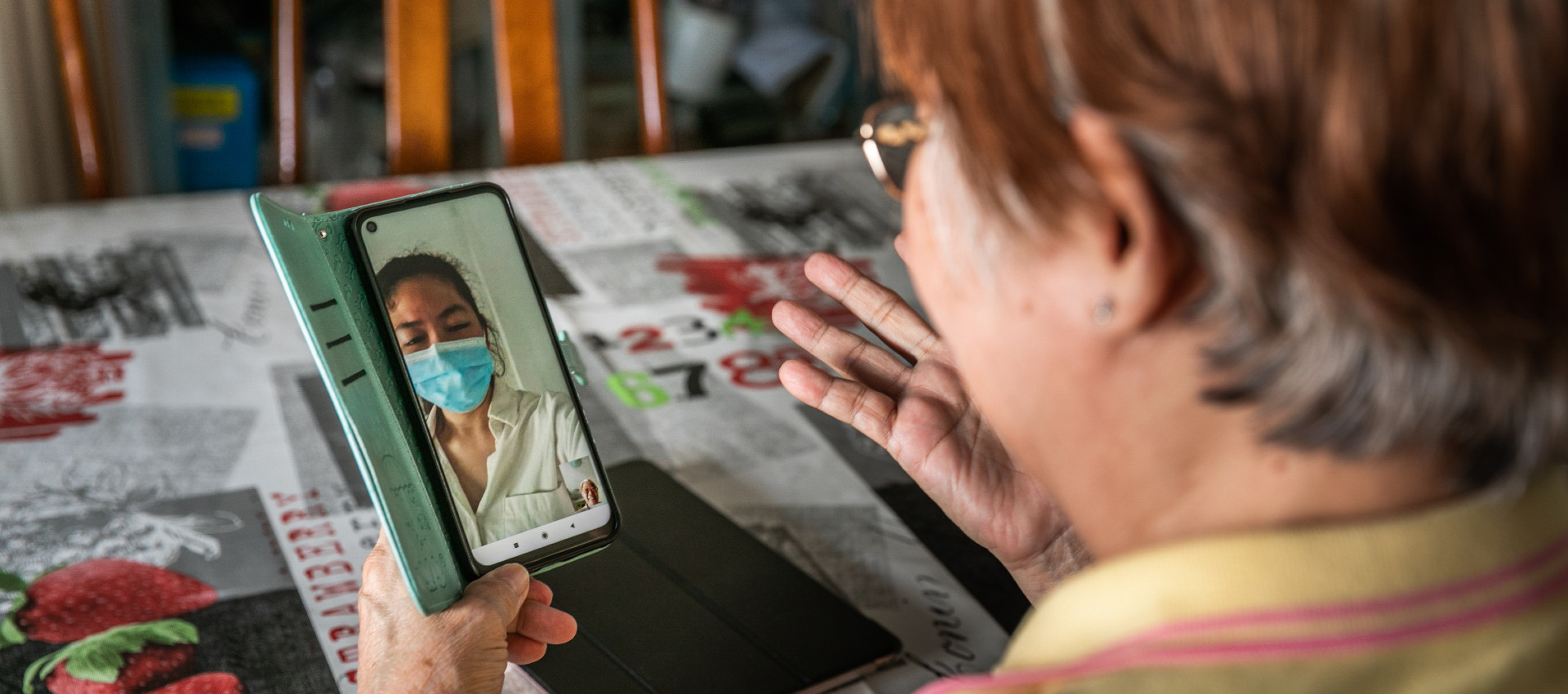 Lady uses a digital device to communicate with a health professional