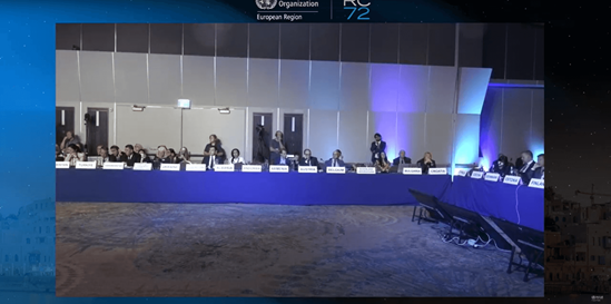 Meeting participants at U-shaped conference tables